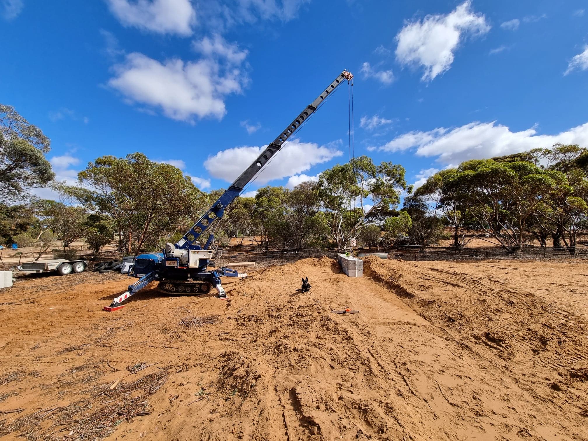 mini crane placing concrete blocks in sandy paddock, Murray Bridge
