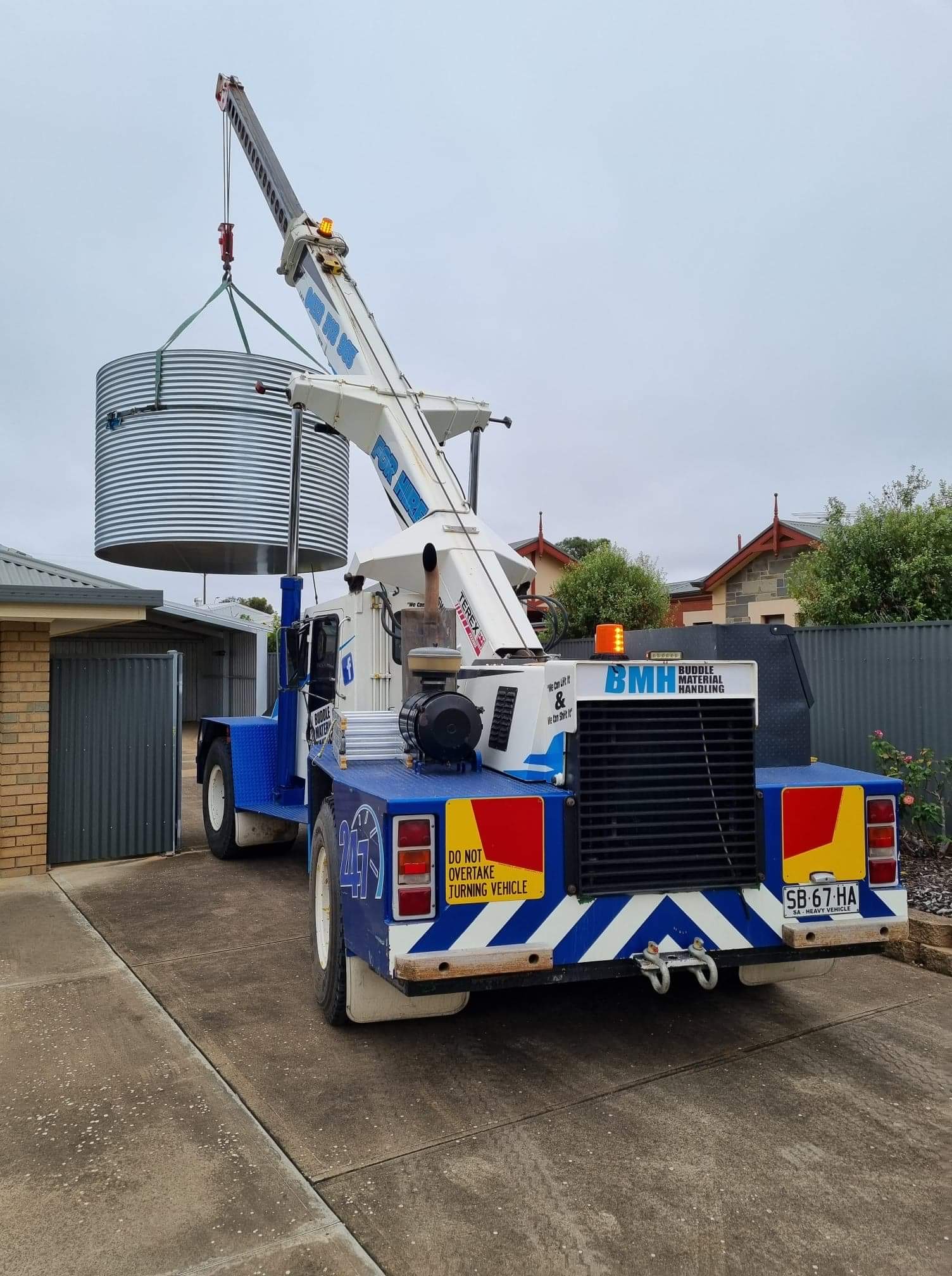 Franna crane hire lifting rain water tank